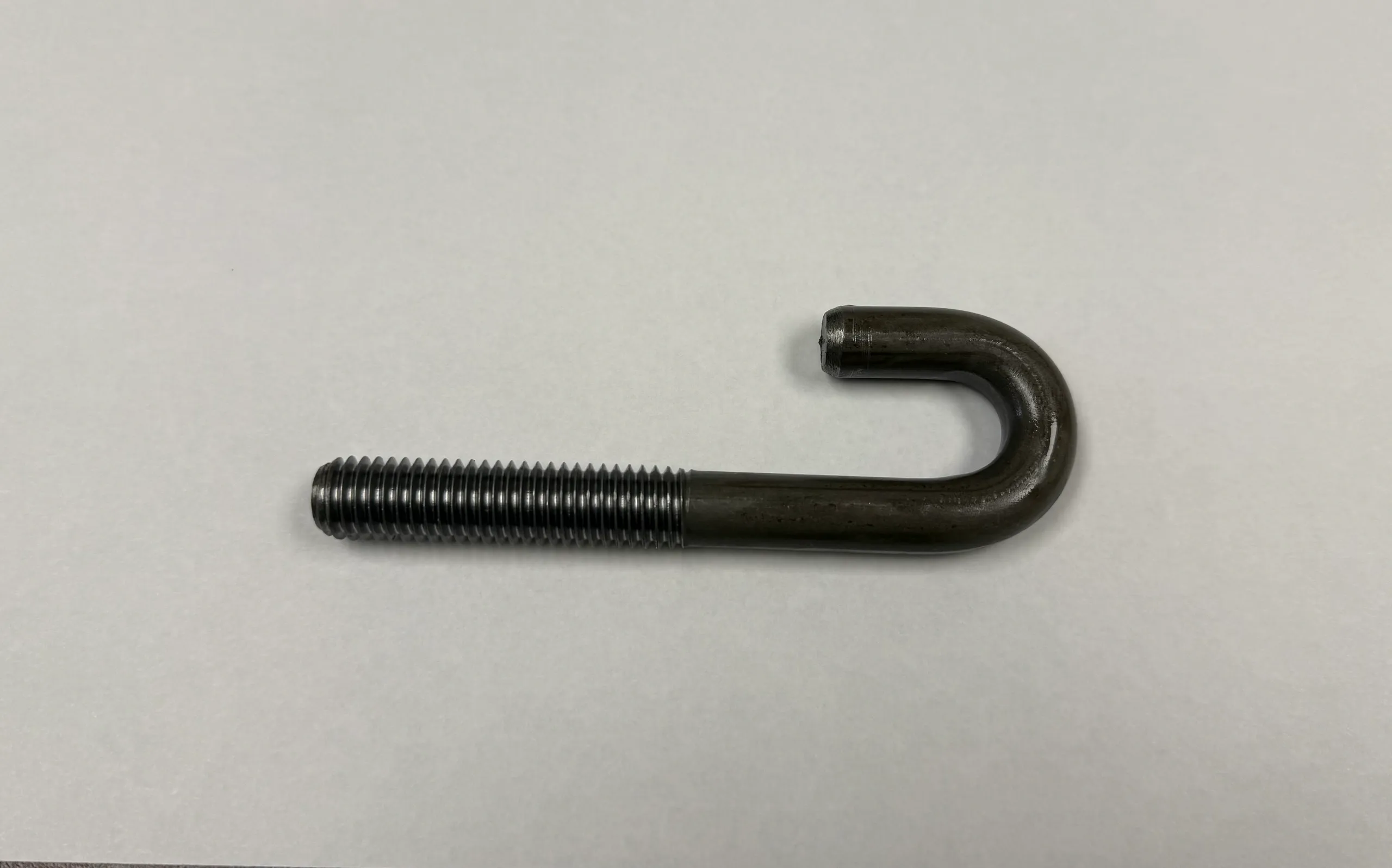 A metal J-shaped bolt with threaded end.