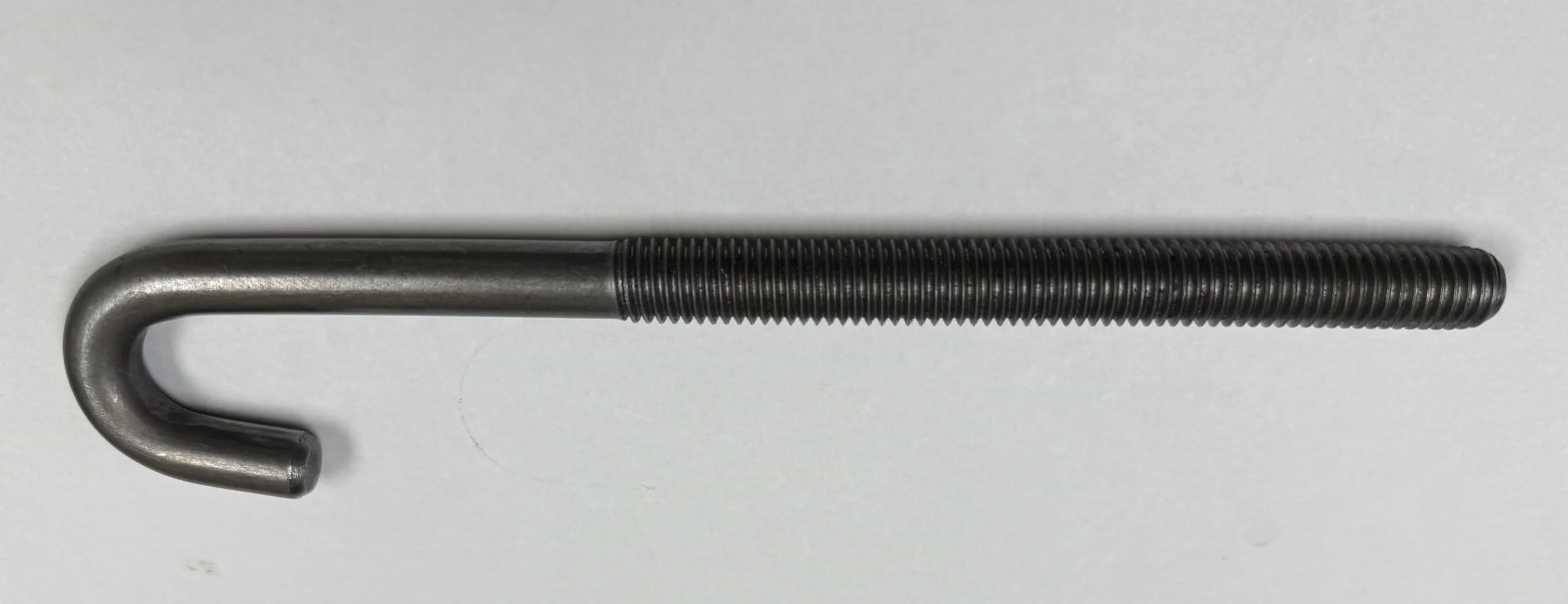 Close-up of a black threaded metal rod.