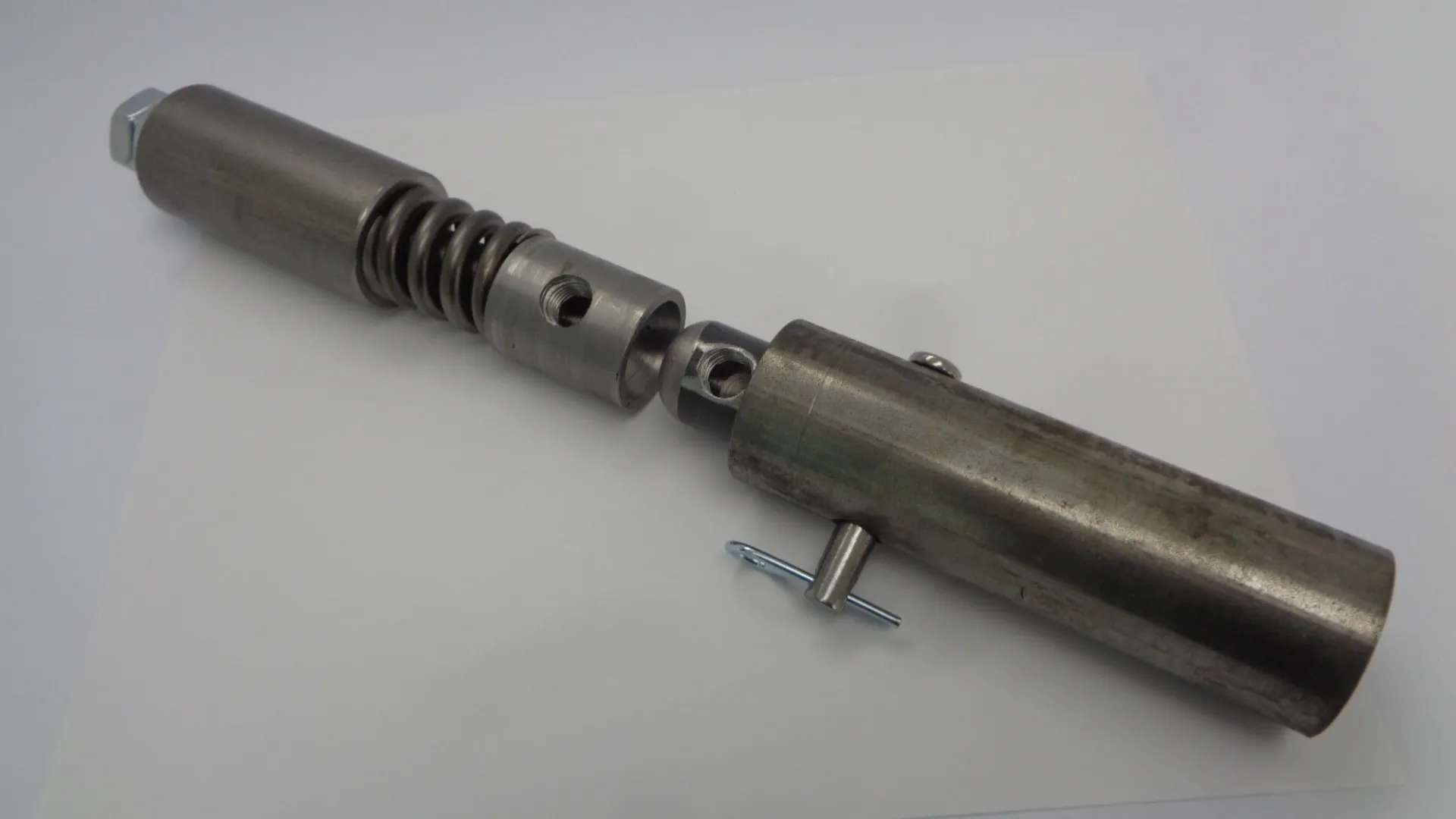 Close-up of a disassembled metal mechanical component with screws.