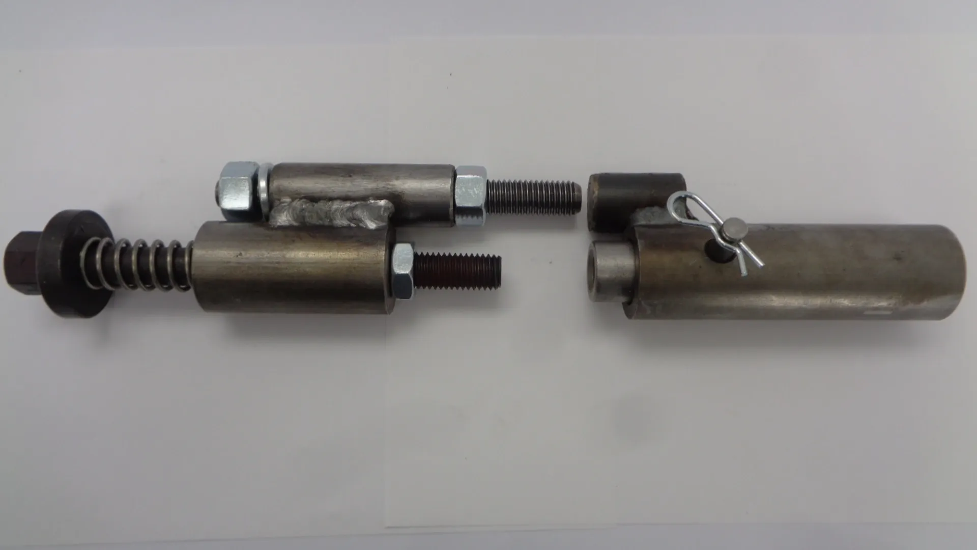 Close-up of two metal mechanical components with threaded ends.